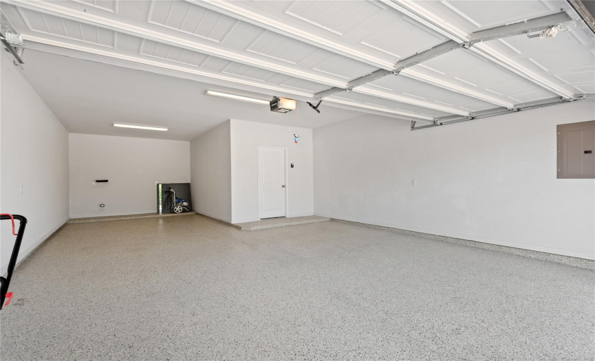 3 car tandem garage with epoxy flooring and water softener loop.