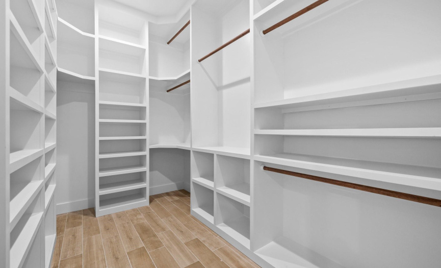 Sitting just off the Primary Bathroom, you will step into this exceptional walk-in closet and immediately feel a sense of luxury and functionality.