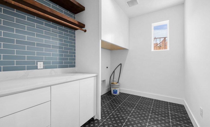 Elevate your laundry experience in this stylish and functional laundry room.  Every detail has been carefully curated to combine practicality with elegance, creating a space that transcends the mundane task of laundry.