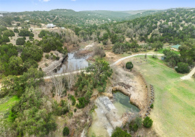 Over 5 acres with natural stream, swimming hole, and gorgeous hill country topography.