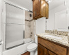 Secondary bathroom features granite counters, shaker style cabinetry and shower/bath combo