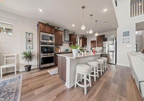 Beautiful kitchen with double ovens, center island, and open to living area