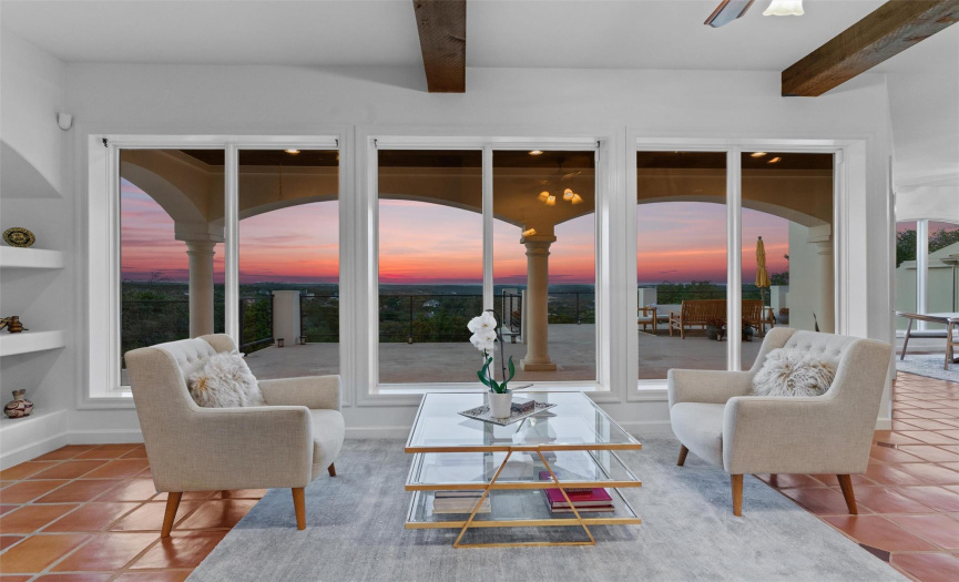 A wall of windows invites the breathtaking hill country views to become an integral part of the luxurious interior, creating a living canvas of natural beauty.