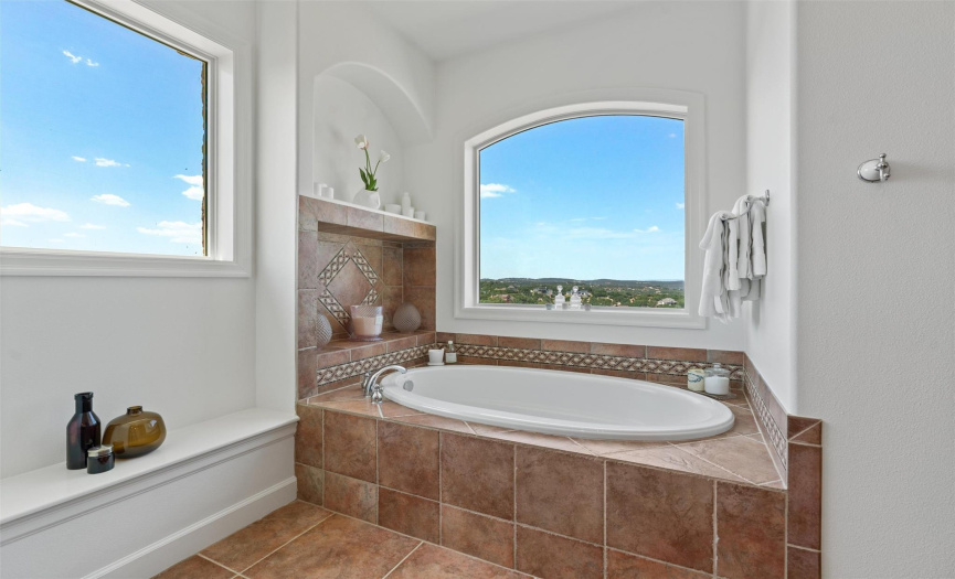 The opulent spa-like ensuite bath is an indulgent retreat, featuring an expansive dual vanity, a freestanding soaking tub, and a lavish walk-in shower.