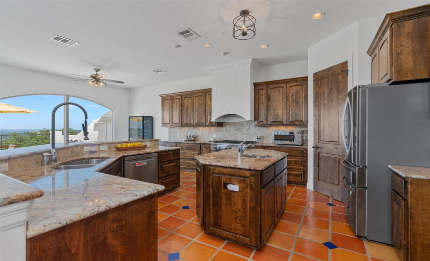 The gourmet kitchen is a culinary haven, where knotty alder cabinets, granite countertops, and chef-style SS appliances create an ambiance of epicurean delight.