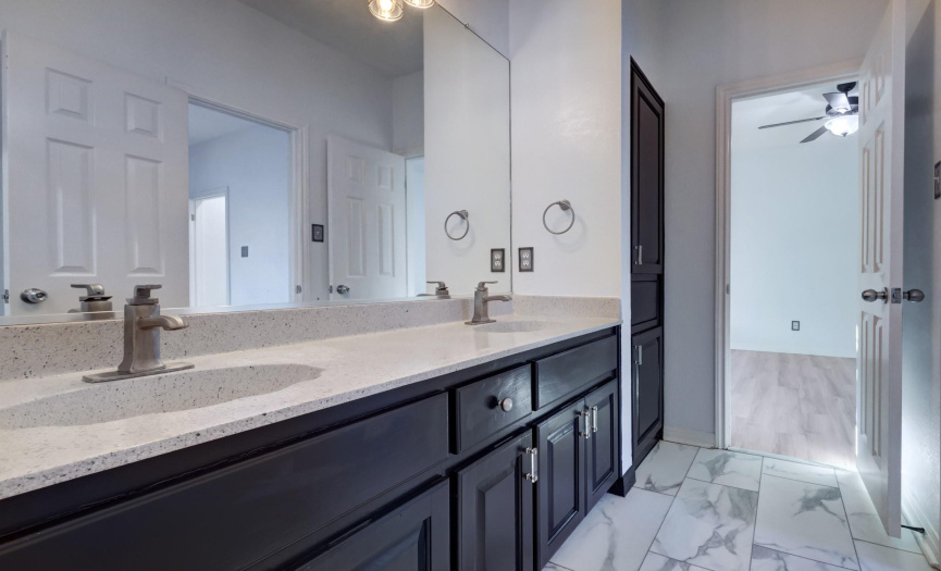 Large expansive dual vanities in the primary bathroom.