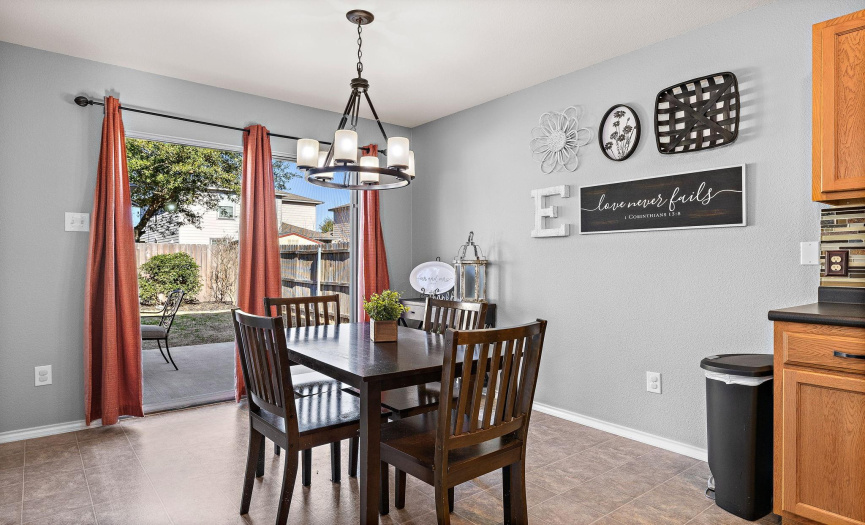Great eat-in kitchen area with updated lighting and sliding glass doors to the outside patio.