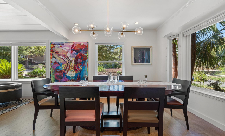Generously sized dining room, accommodating up to six people comfortably, enhanced by a striking lighting fixture