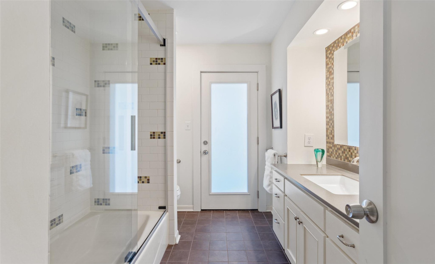 Full bathroom with shower tub combo, vanity with single, and gorgeous tiled flooring