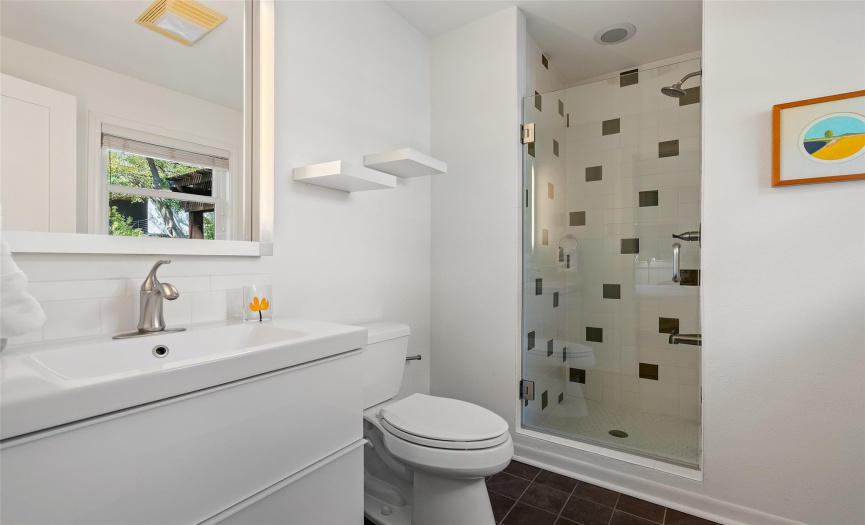 3rd bathroom with sleek tiled standing shower 