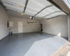 Epoxy garage floor with ceiling storage racks