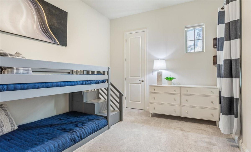 A secondary bedroom with a walk-in closet