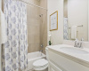 Nestled next to a full bathroom, providing a comfortable retreat for guests or family members.