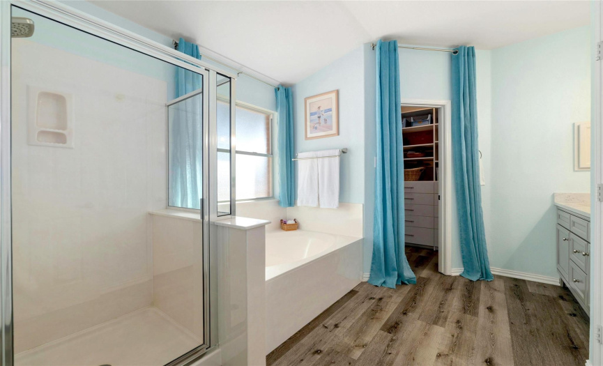 The bedroom includes an en-suite bath complete with a large soaking tub and glassed-in shower. 