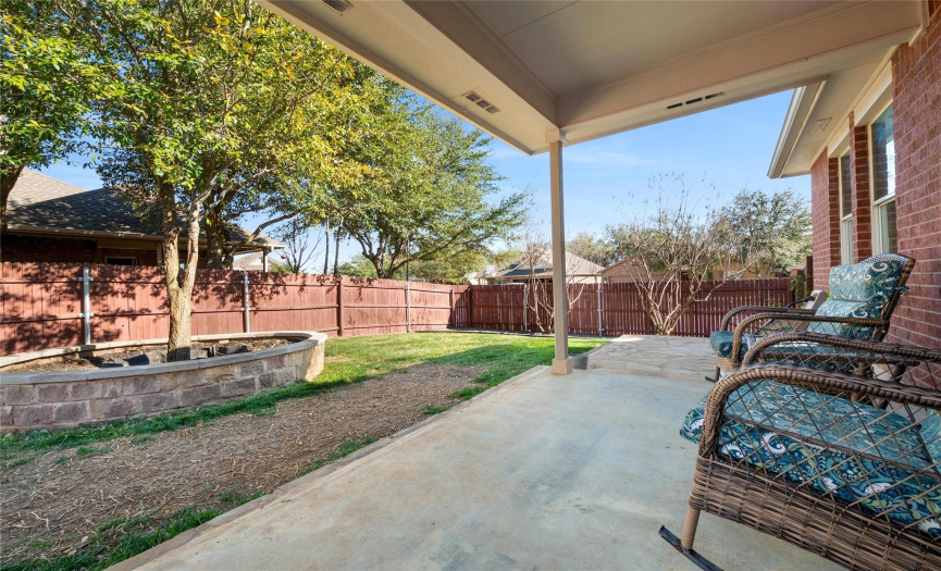 Two rock patios flank the covered patio so that you have ample space for lounging outside.  Can’t you imagine enjoying peaceful evenings on the covered patio looking out over the large, landscaped lot?