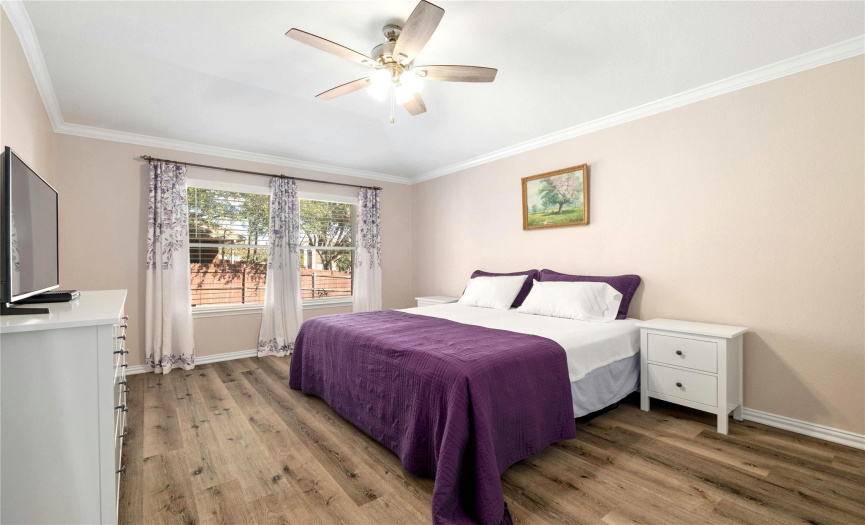 The home includes a spacious primary bedroom with a double window overlooking the backyard.
