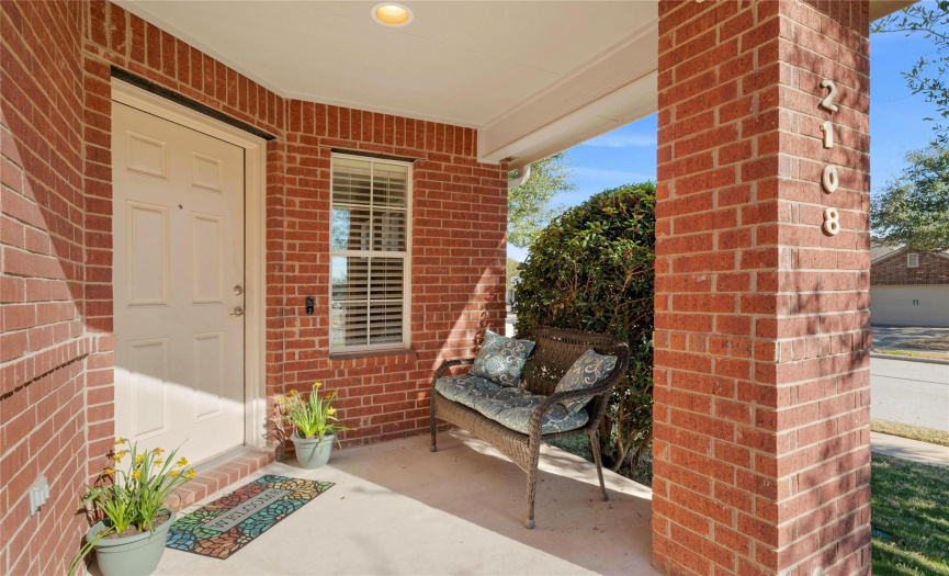 This nicely appointed home offers excellent curb appeal with striking red brick masonry, well-maintained landscaping accented by two Live Oak trees, a covered front entry, and two-car garage. 