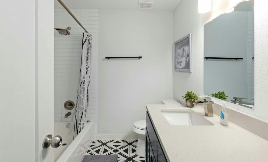 The shared bathroom on the upper floor is designed with modern elegance, providing easy access from both bedrooms and featuring contemporary fixtures and finishes.