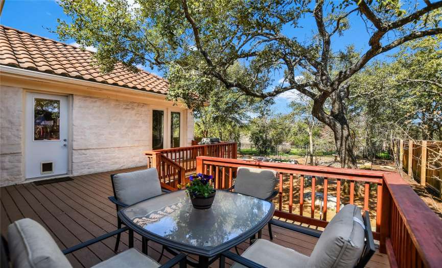 Imagine heading out to this well-shaded back deck after the end of a long day and taking in the peaceful sounds and views of the greenbelt behind the home.