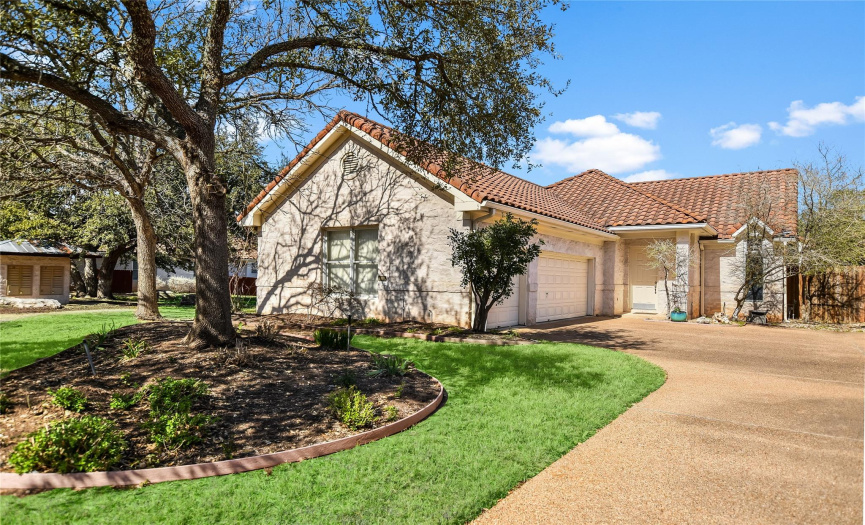 Situated on a beautifully landscaped corner lot, this home provides gorgeous curb appeal with elegant stucco & stone masonry, a tiled roof, and towering shade trees. 