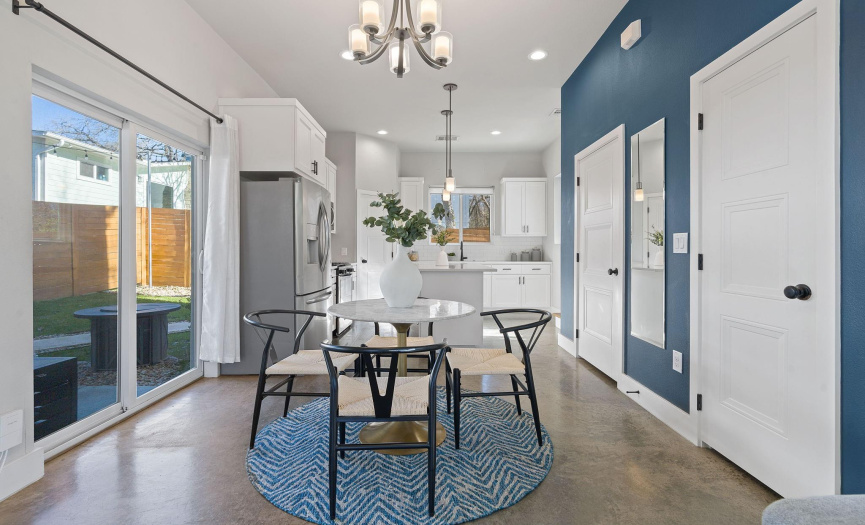 The centrally located dining area provides plenty of space for a sizable dining table and is located alongside the sliding doors to your private patio & fenced-in yard. 
