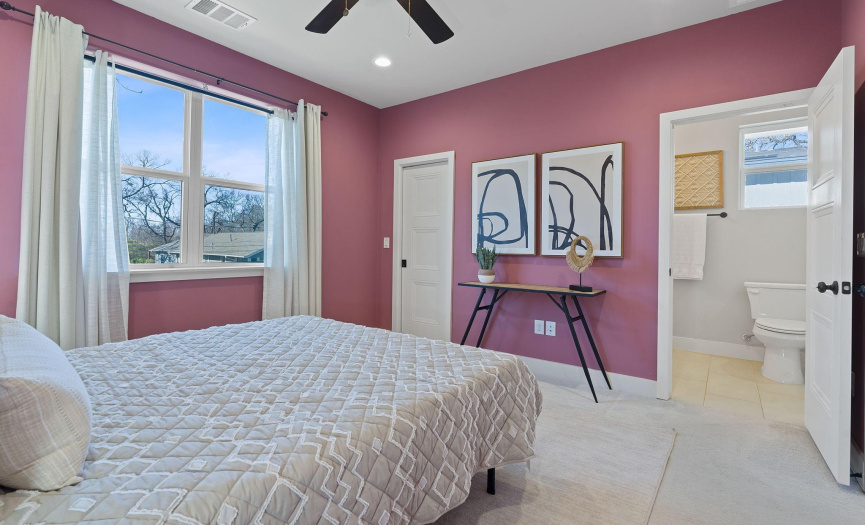 The primary bedroom provides a nice walk-in closet with a stylish pocket door and lovely tree-top views that you can enjoy while relaxing in bed. 