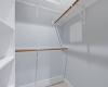 The walk-in closet provides convenient built-in shelving. 