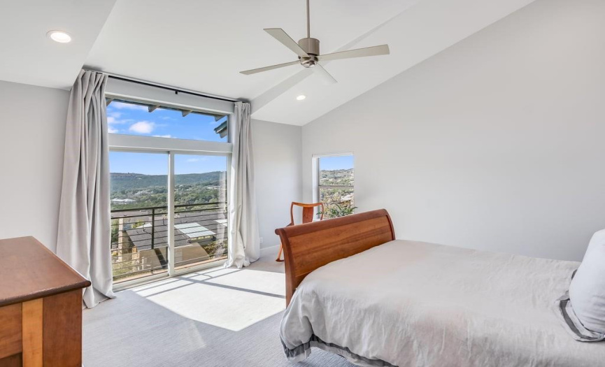 Large Primary Bedroom features high vaulted ceilings and a view to the hills