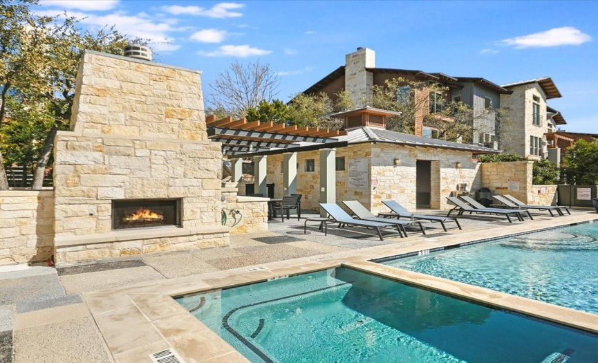 The large fireplace makes this poolside area inviting yearround.