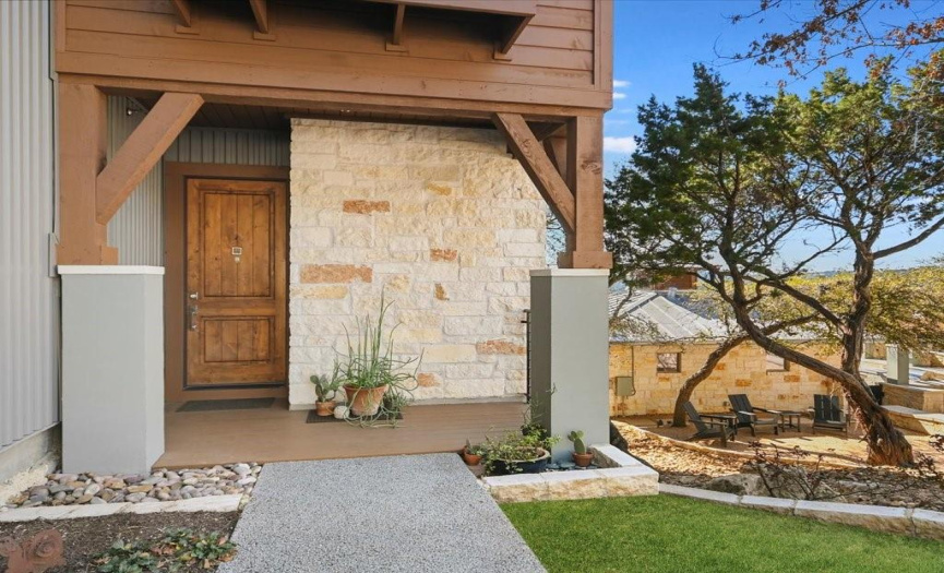 Exterior entry features metal siding, natural stone and a solid Alder front door that leads into the stunning interiors and the views