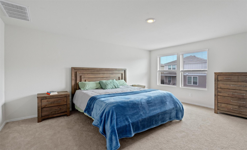 Relax and rejuvenate in the spacious primary bedroom.