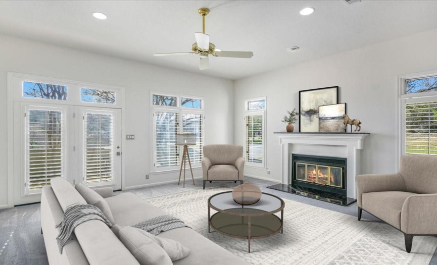 The spacious interior is illuminated by natural light, featuring high ceilings, large windows, elegant plantation shutters, and ceramic tile flooring throughout the main floor. *Virtually Staged*