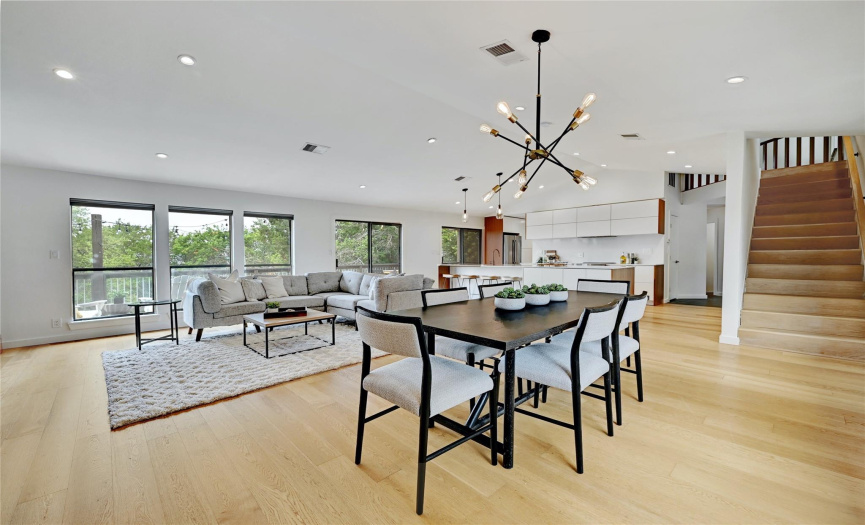 Boasting high vaulted ceilings, gorgeous hardwood flooring, low-e windows, and modern light fixtures throughout.