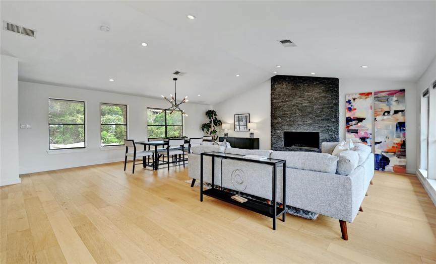 Boasting high vaulted ceilings, gorgeous hardwood flooring, low-e windows, and modern light fixtures throughout.