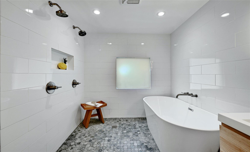 The spa bath also features an open walk-in shower with dual shower heads.