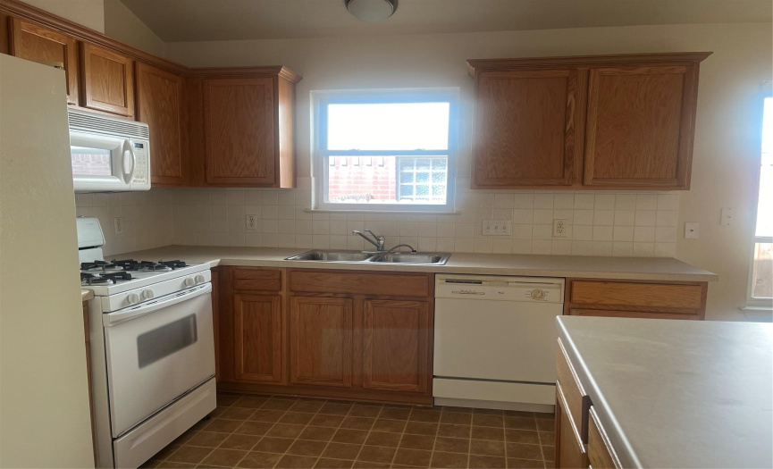 View of Kitchen showing cabinets, gas stove, microwave and diswasher  