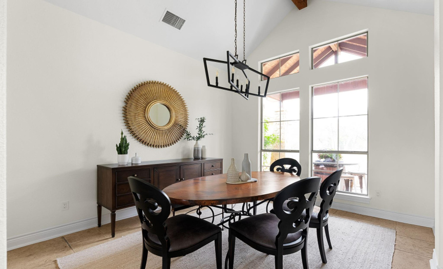 Lovely formal dining area with soaring ceilings, a beam, and transom windows. Loving the natural lighting! 