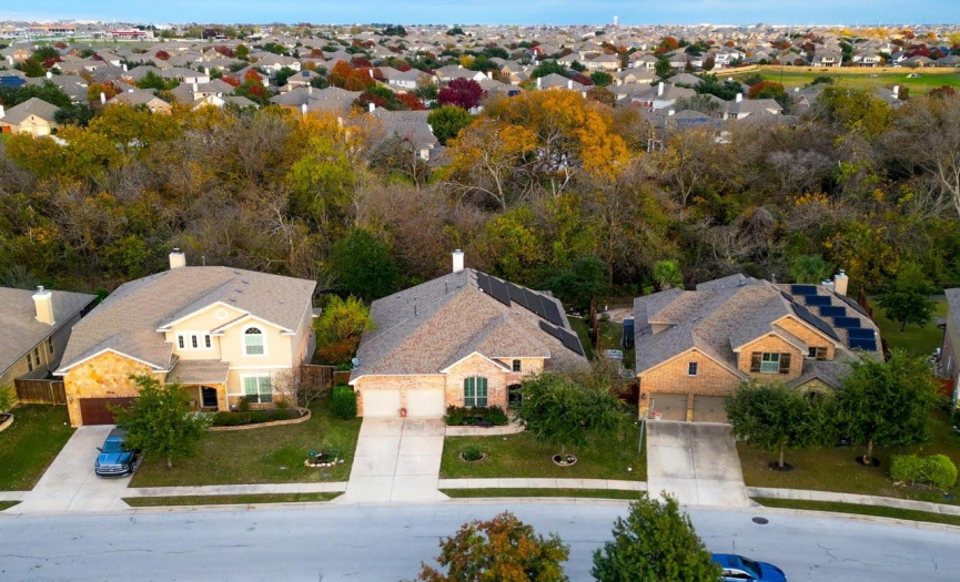 Ariel view showing green space behind home.