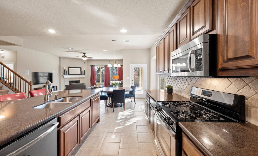 Featuring granite countertops, sleek SS appliances, and abundant cabinetry storage & counterspace.