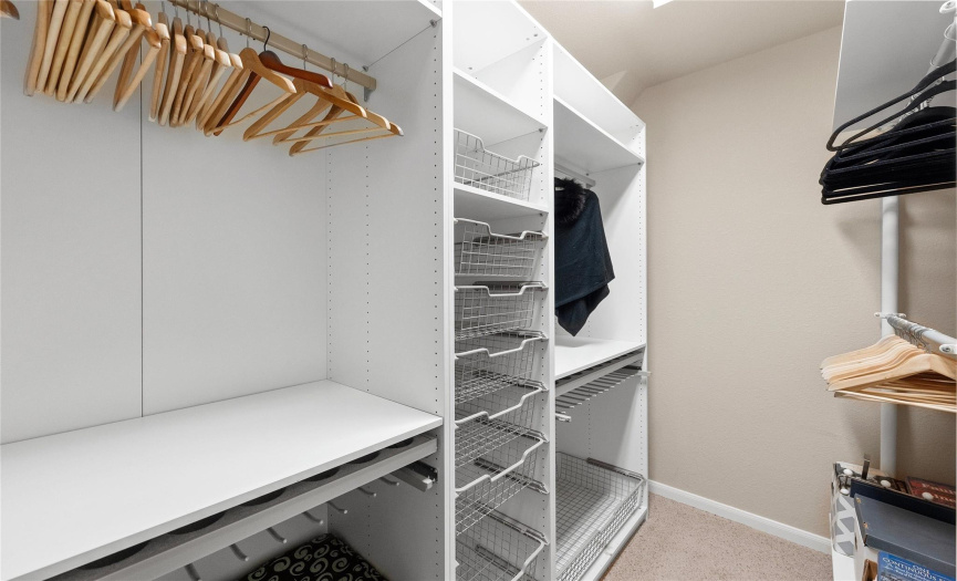 The primary walk-in closet features a fabulous organizational system. 