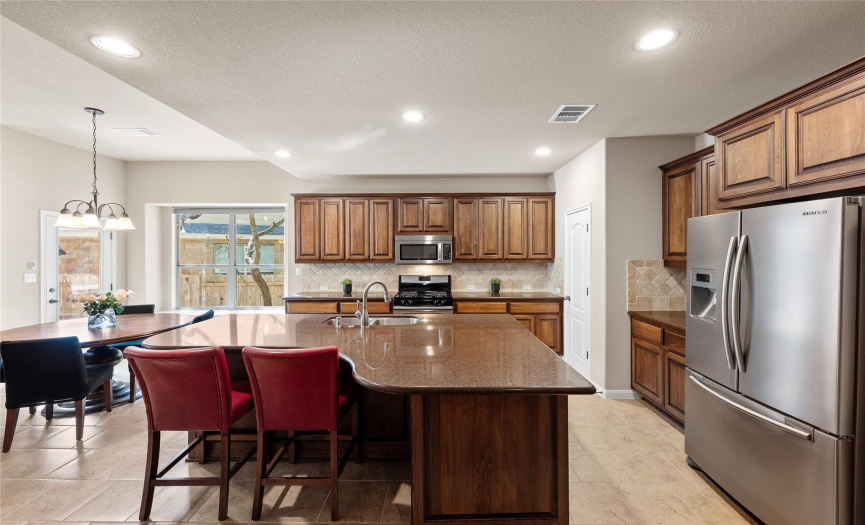 The bright and spacious kitchen is sure to please the home chef with desirable modern features. 