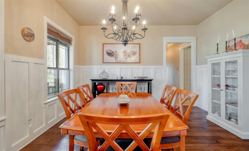 Entertain in style in the formal dining area, accented with board & baton detailing & an elegant chandelier. 