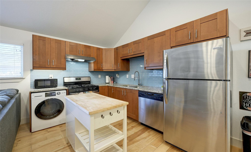 Stainless range, dishwasher and combo washer/dryer included.