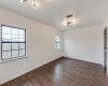 Synthetic well-maintained hardwood floors and closet that houses washer and dryer.