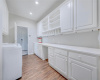 Lengthy laundry room with wash basin adjoins useful enclosed storage or mud room!