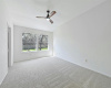 Primary bedroom, updated carpet and private and serene view to backyard