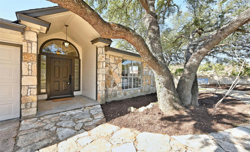 Beautiful large oak tree graces the entrace to the home