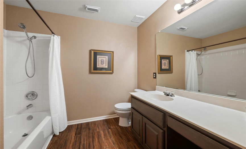 The secondary full bathroom has updated flooring and is located conveniently to the bedrooms. 