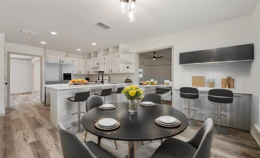 The breakfast area is open to the kitchen and has a great view into the backyard. All the light fixtures have been replaced throughout the home. *Virtually Staged Photo*