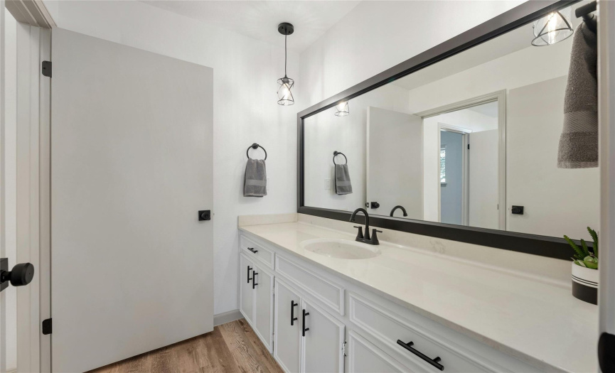 Notice all the amazing updates in the additional bathroom. The modern pendants add an elegant touch to this space.